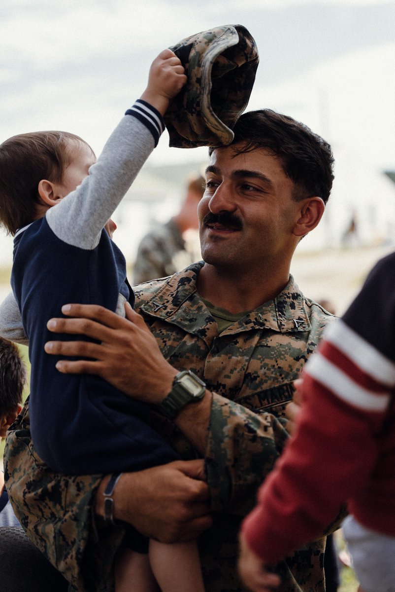 U.S. Marine Corps Lance Cpl. Nima H. Najafabadi , a machine gunner with 3rd Battalion, 6th Marine Regiment, plays with an Afghan child on Fort Pickett, Virginia, Oct. 13, 2021.