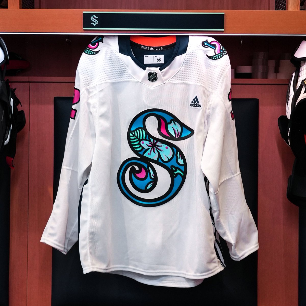 Image of the front side of the pride night warmup jersey hanging up in locker
