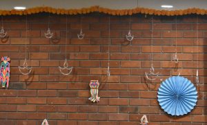 A brick wall decorated with various hanging ornaments.