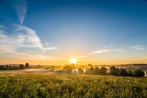 Sunrise viewed over some fields near Schwerin. Sun rays and Fog.