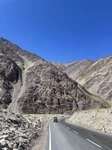 A car driving on a road going through the mountain valleys.