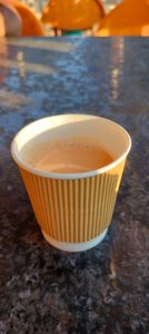 A cup of tea on a dark table in soft morning light.