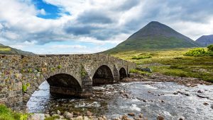 Ancient stone bridge over a river in the Scottish Highlands — a symbol of endurance, permanence, and long-term nonprofit sustainability through endowment giving.