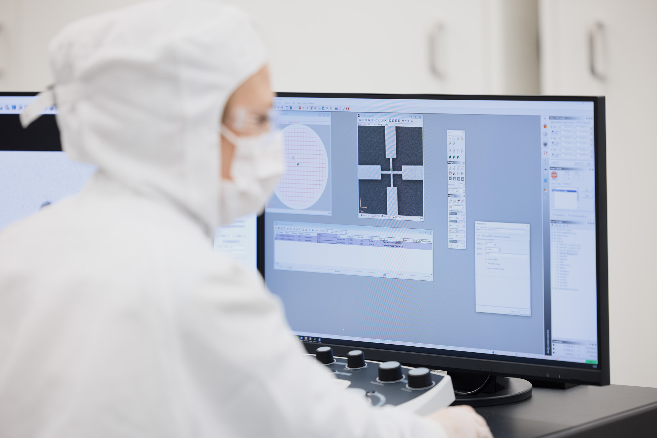 Worker in protective gear operating on nanolithography software digitial RAITH.