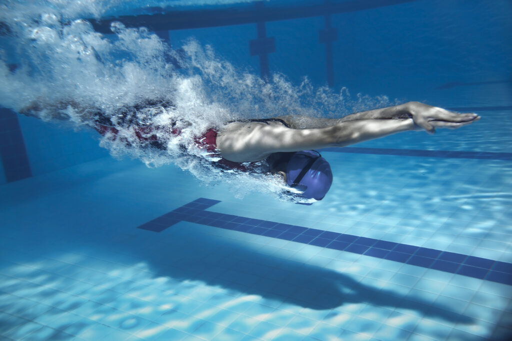 Swimmer diving into pool