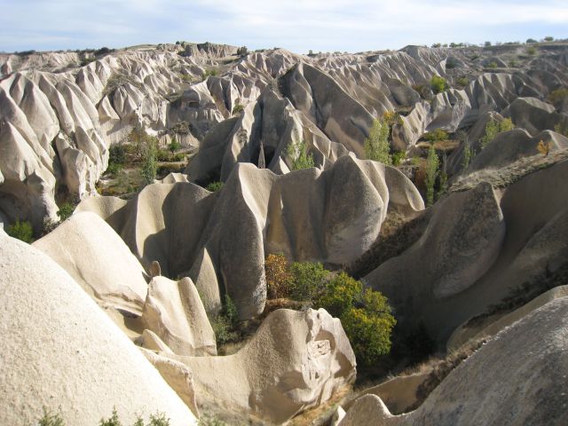 Amongs the strange rock formations lie beautiful green valleys, with grass, trees, and fields for farming. (Very bizarre.) I spent a great day walking these valleys.