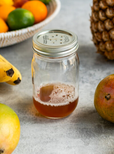 Mason jar filled with homemade fruit fly trap solution.