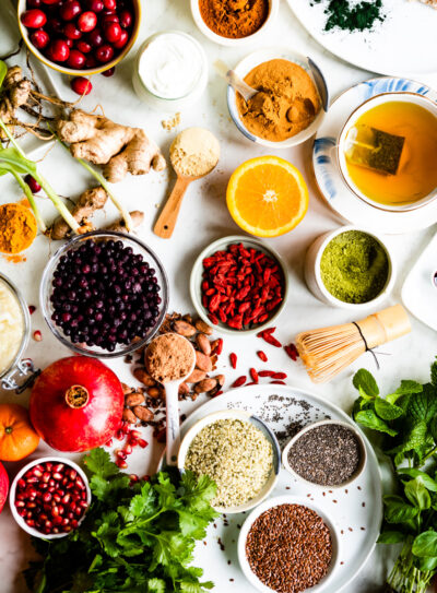 white counter full of bowls of different superfoods.