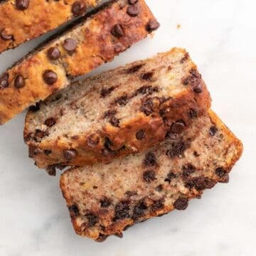 Sliced vegan banana bread on marble.