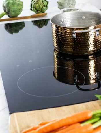 induction cooktop with pot and veggies