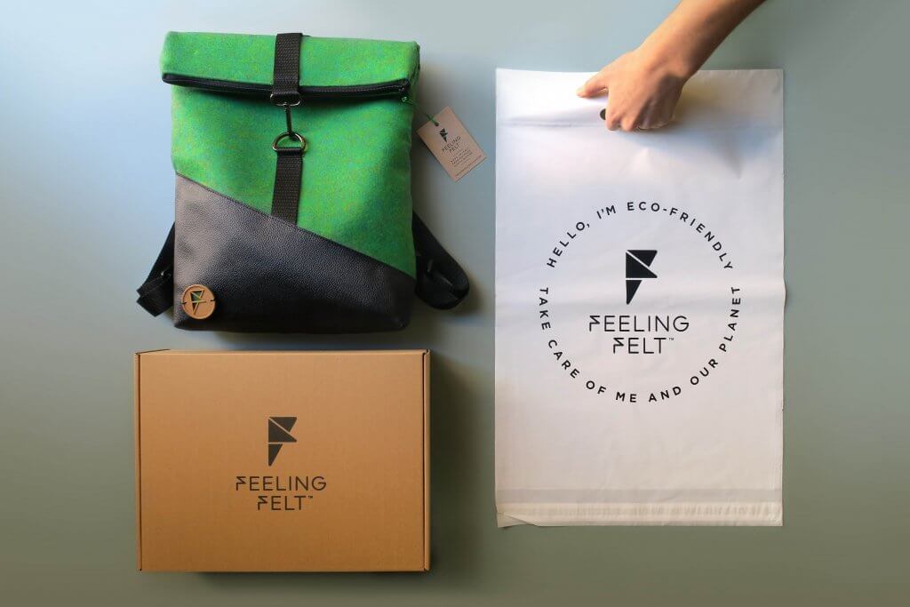 green backpack with an eco mailer box and bio poly mailer