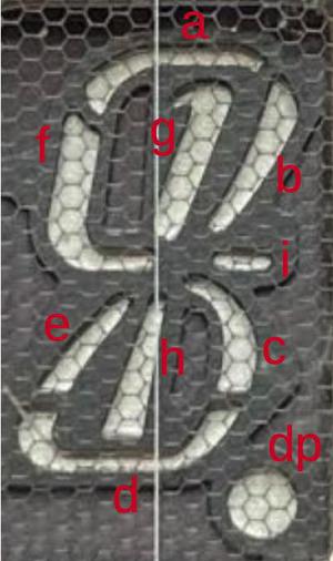 The 9-segment vacuum fluorescent display tube used in the QT-8D calculator. The vertical line down the middle is the heated cathode and the hex mesh is the grid. The 9-segment vacuum fluorescent display tube used in the QT-8D calculator. The vertical line down the middle is the heated cathode and the hex mesh is the grid.
