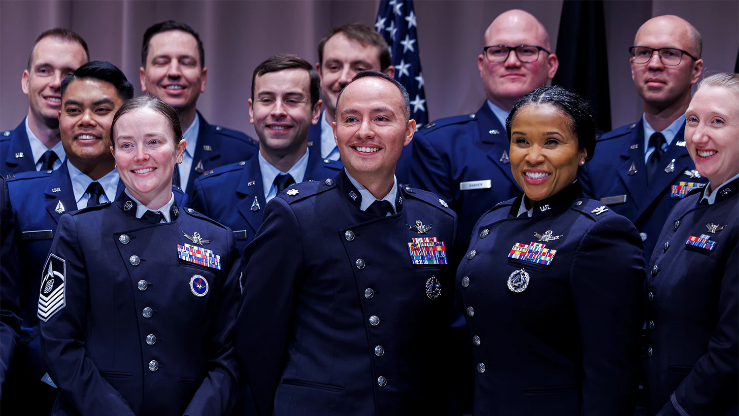 Smiling members of the U.S. Space Force in military dress