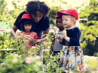Nursery Manager show children plants in a garden to capture on Tapestry Childhood Education Platform