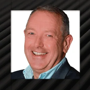 Close-up of a smiling business professional in a suit, representing corporate leadership and success.