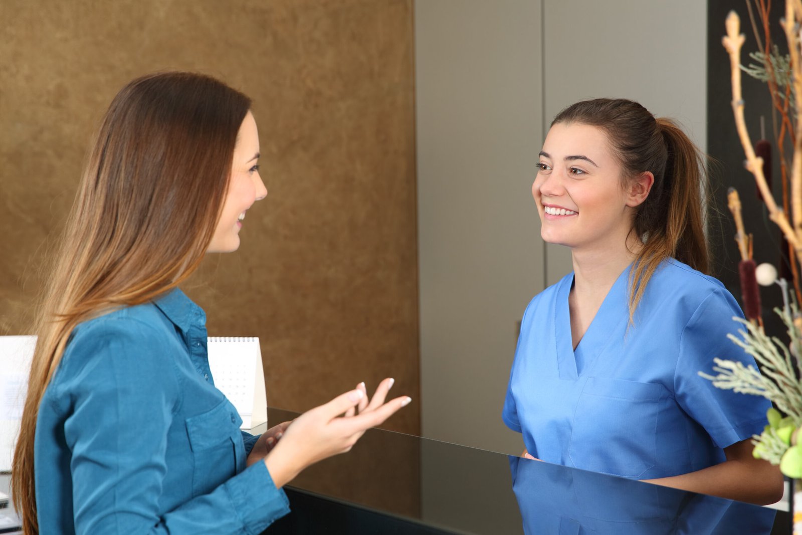 Nurse attending patient in a reception desk The Learning Company - Health Unit Clerk