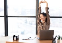 How Employee Wellbeing Is Your Strategic Advantage in the AI Era Good,Morning.,Happy,Female,Manager,Stretching,Her,Body,And,Arms