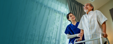 Nurse helping patient with a walker