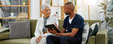 Man sitting with elderly woman