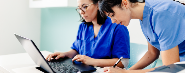 Woman looking at laptop.