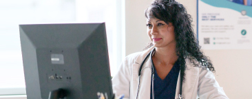 Healthcare worker using computer.