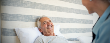 Healthcare worker and patient interact.