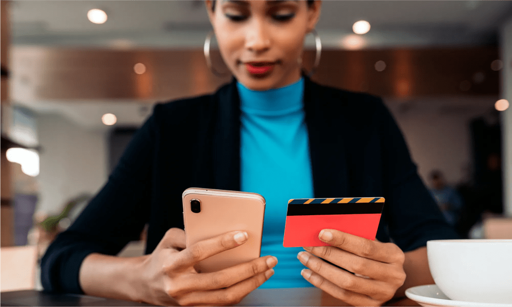 A WordPress VIP Technology Partner holding a phone and credit card