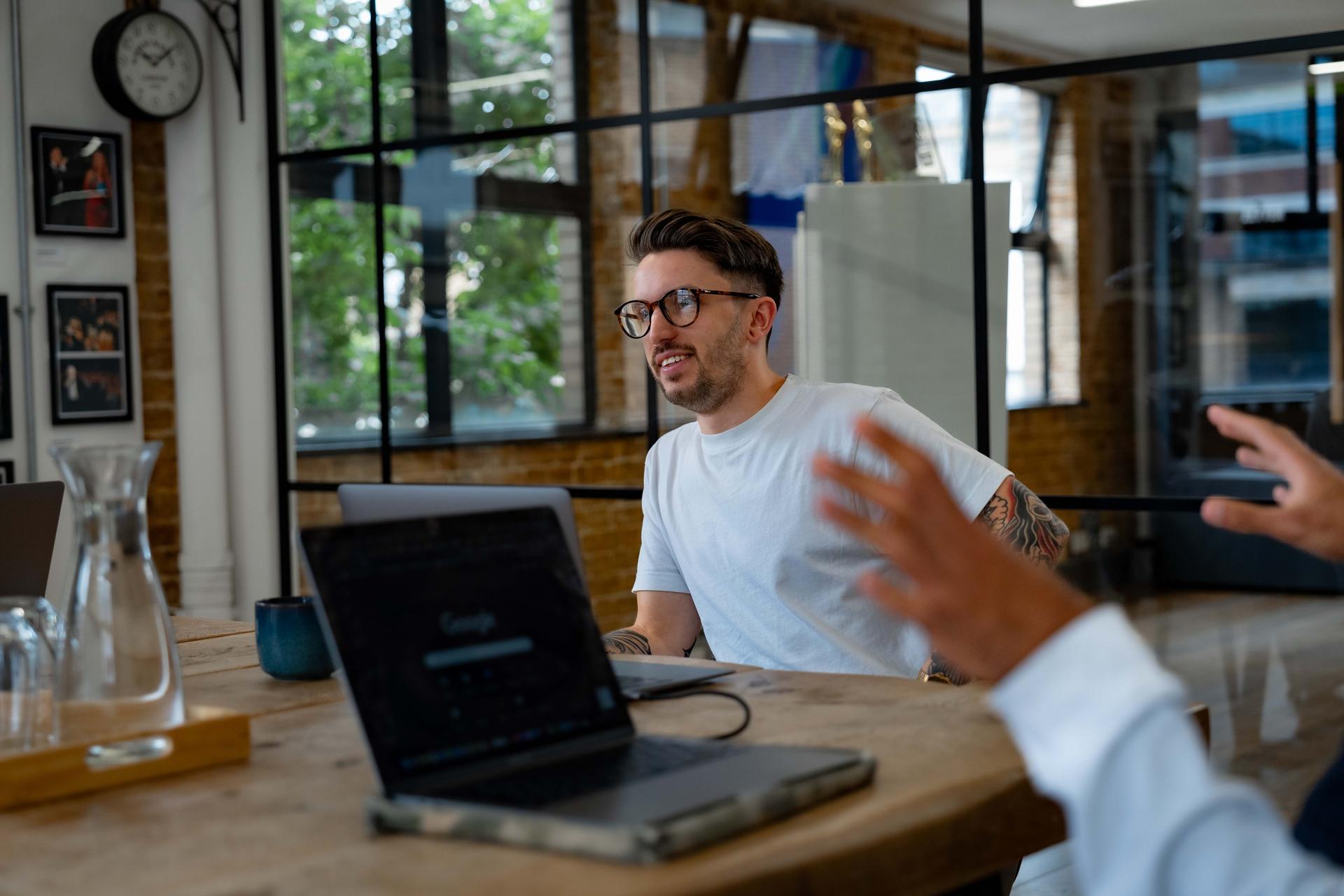 James leading a meeting in a bright meeting room