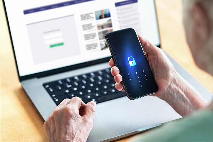 Older woman using phone system security for her online banking