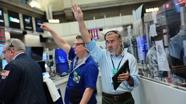 Traders work on the floor of the New York Stock Exchange. Traders work on the floor of the New York Stock Exchange.