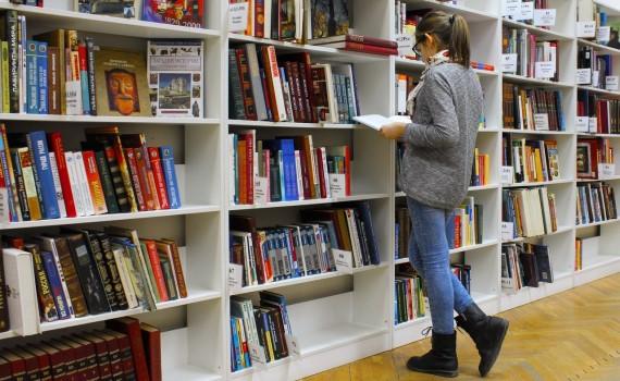 catalog help woman browsing bookshelves