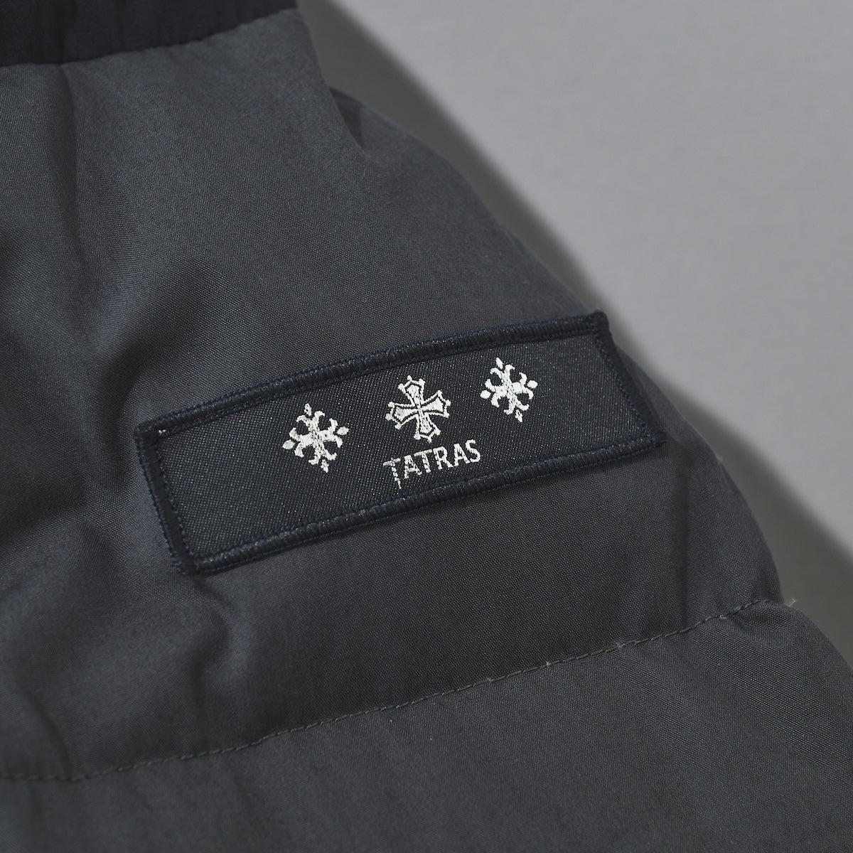 タトラスのAILANTO アイラント ダウンジャケット ロゴ部分