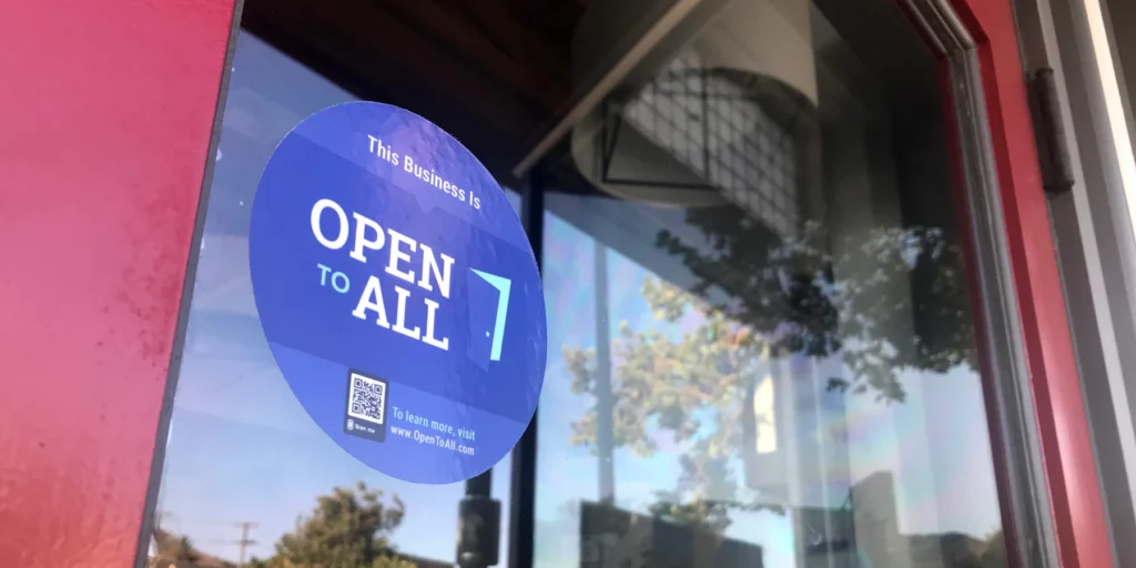 Open to All cling on a glass door