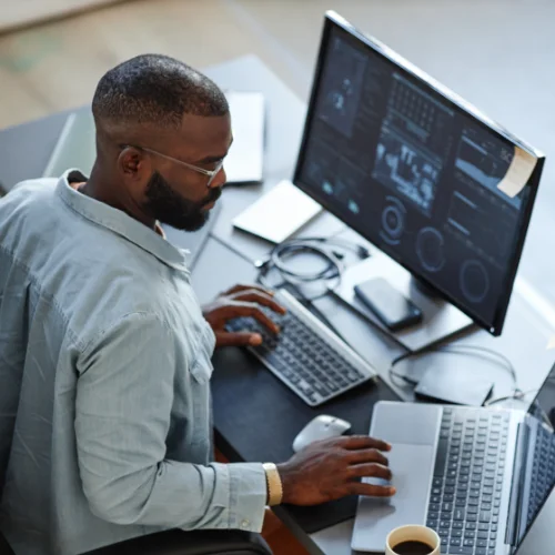 Man working on desktop computer using Opus Interactives secure cloud technology.