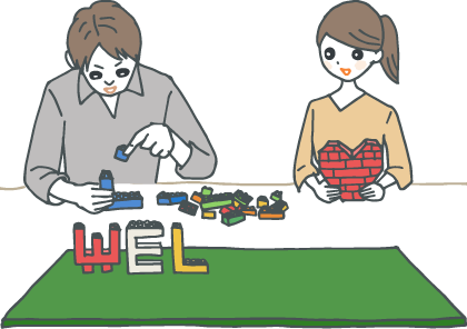 イラスト:レゴブロックでウェルカムメッセージを作る新郎新婦