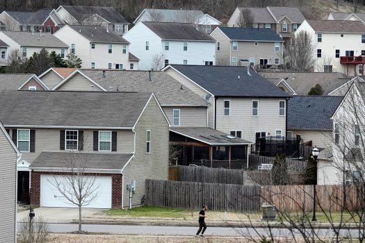 AP26042095358863 A person jogs past single family homes, Tuesday, Feb. 10, 2026, in Nashville, Tenn. (AP Photo/George Walker IV)