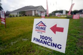 Immigration_Colony_Ridge_89612 FILE – A sign promoting 100% financing is displayed outside a model home in the Colony Ridge development in Cleveland, Tx., Oct. 3, 2023. (AP Photo/David J. Phillip, File)