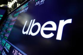 Uber-Assault_Verdict_29123 FILE – The Uber logo appears above a trading post on the floor of the New York Stock Exchange, Aug. 16, 2019. (AP Photo/Richard Drew, File)