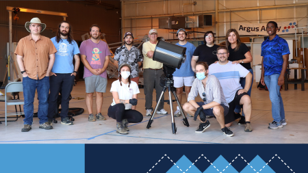 Professor Nicholas Law and the Argus Array team pose for a photo in a warehouse.