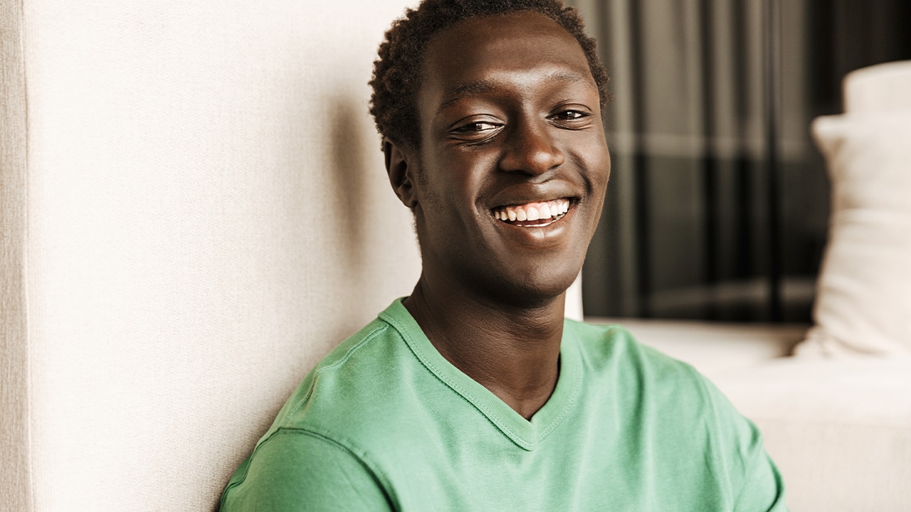 student smiling wearing green shirt